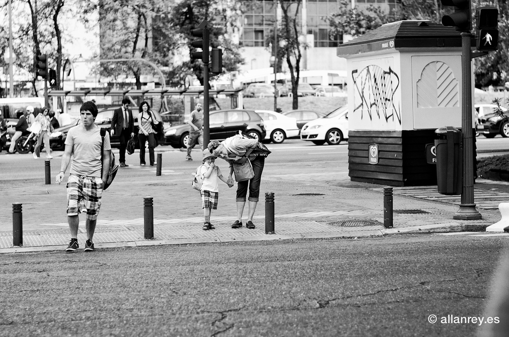 An old man in a farmacy undecided what sunglasses to buy